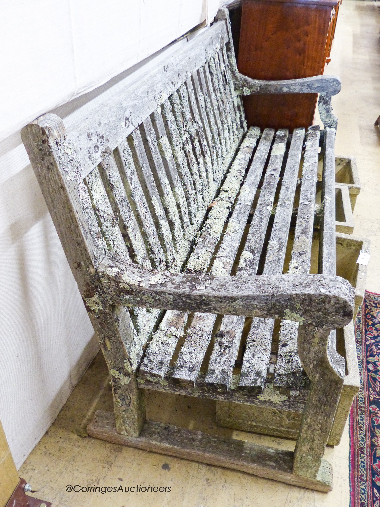 A weathered teak garden bench, length 182cm, depth 68cm, height 94cm